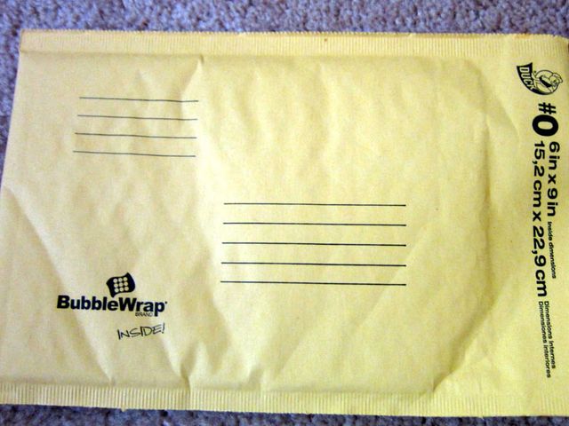 A flat paper padded mailing envelope with printed address lines