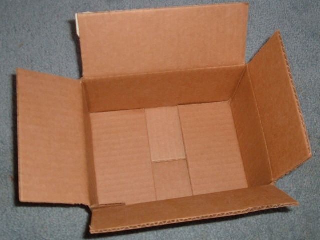 An open brown corrugated box seen from above, flaps folded out