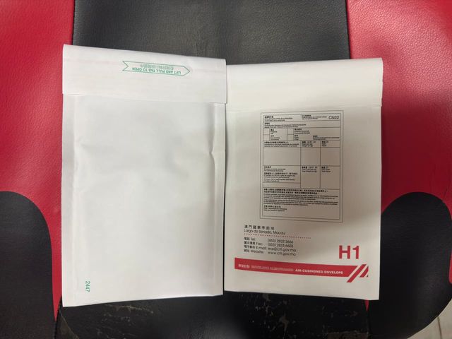 Two white plastic mailing envelopes laid side by side