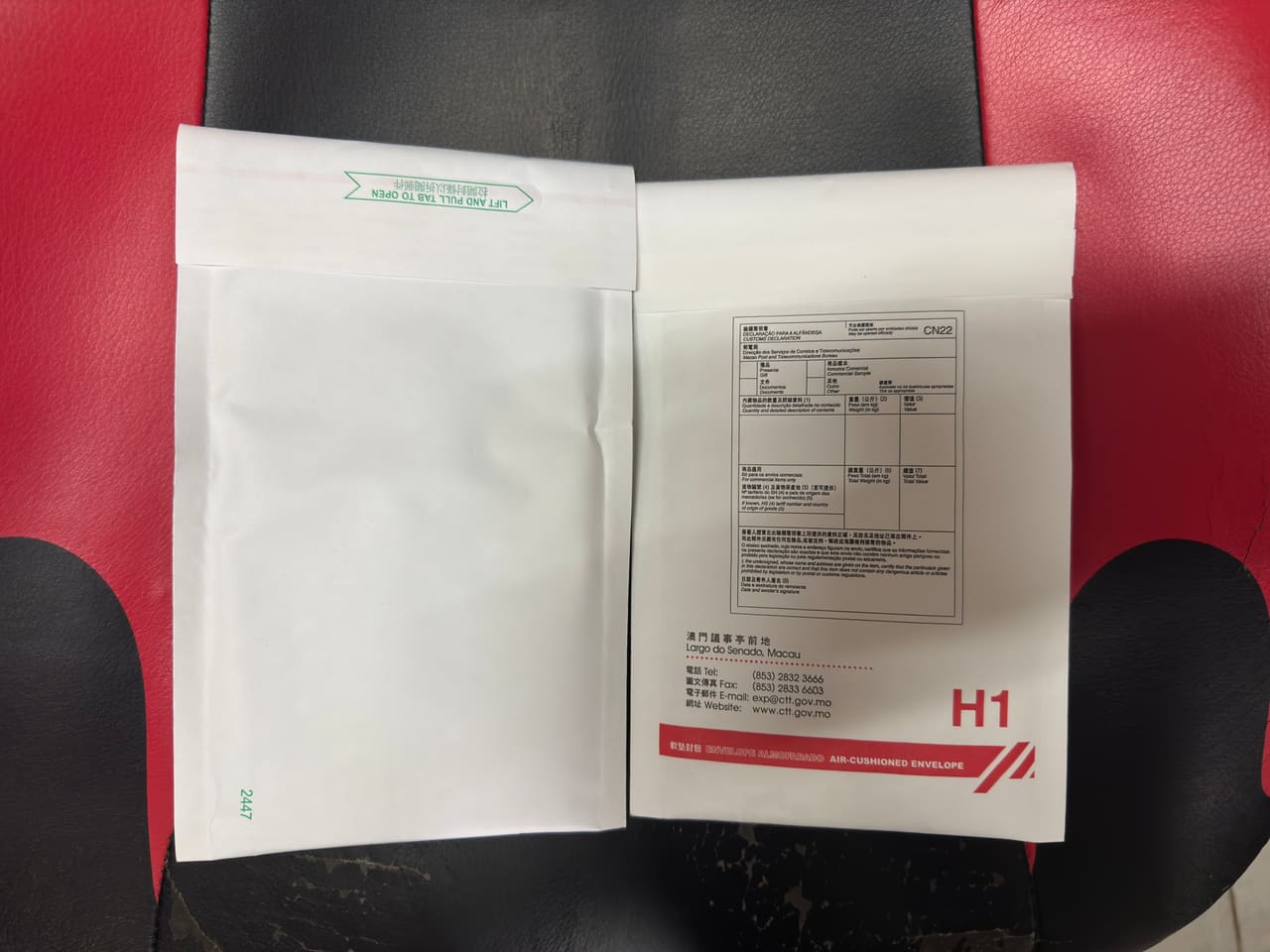 Two white plastic mailing envelopes laid side by side